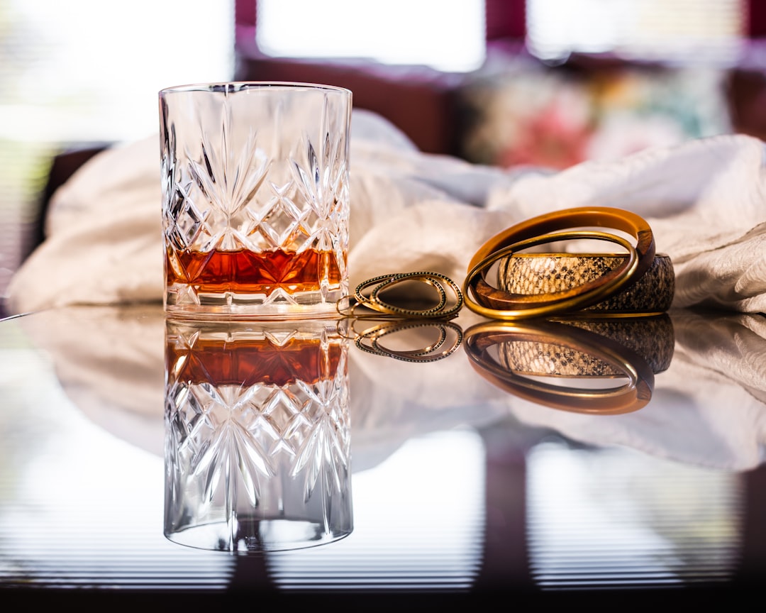 clear drinking glass with brown liquid