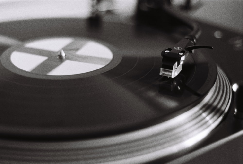 black vinyl record on vinyl record player