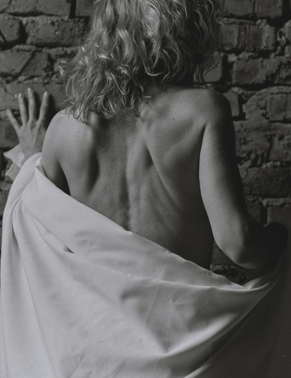 topless woman covered with white blanket