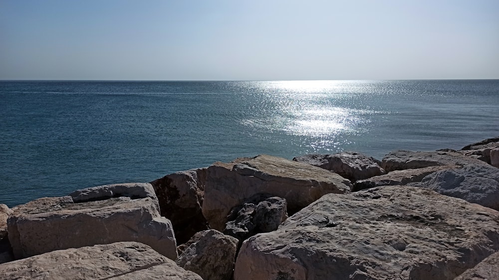 brown rock formation near body of water during daytime