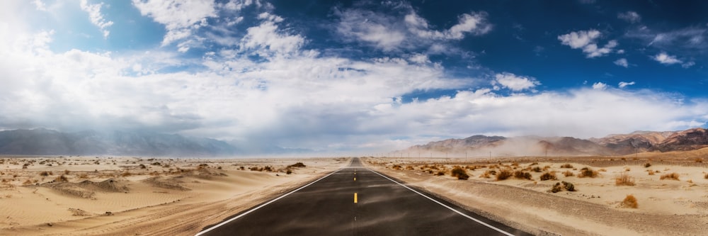 Carretera de asfalto gris bajo el cielo azul durante el día