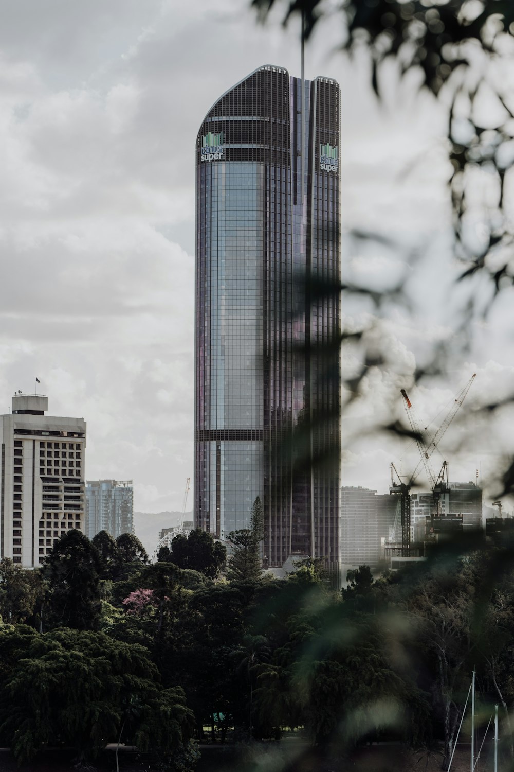 high rise building under white clouds during daytime