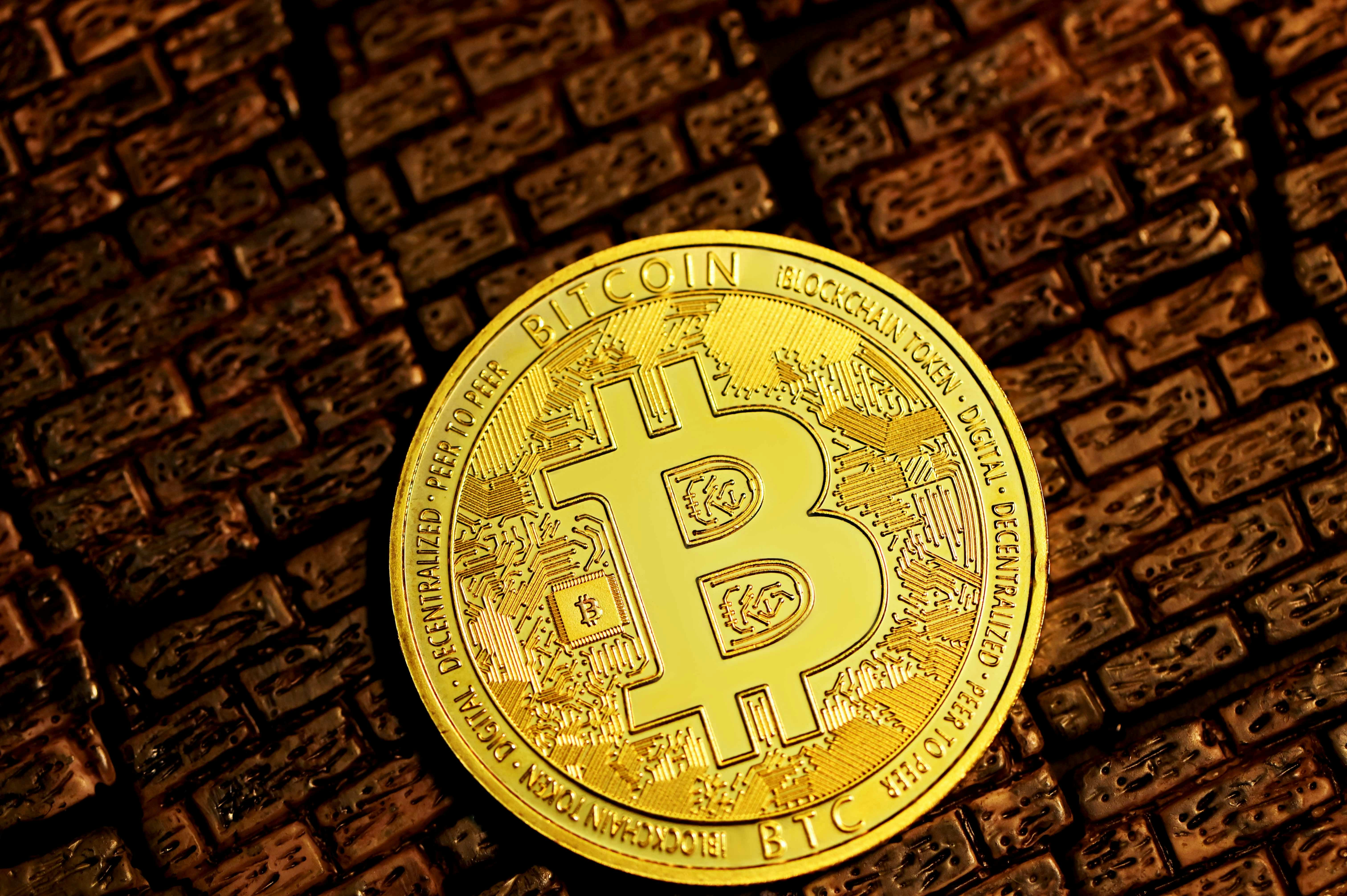 A bitcoin coin on top of the bricks