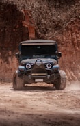 blue and black jeep wrangler on dirt road during daytime