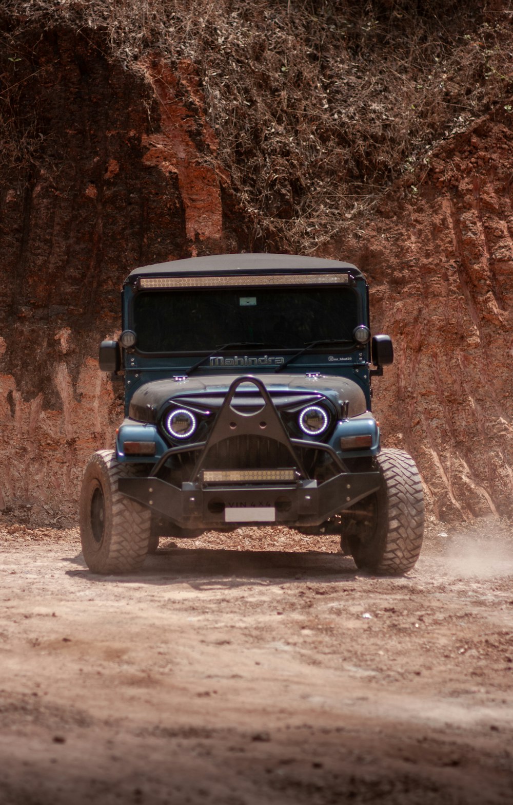 blue and black jeep wrangler on dirt road during daytime