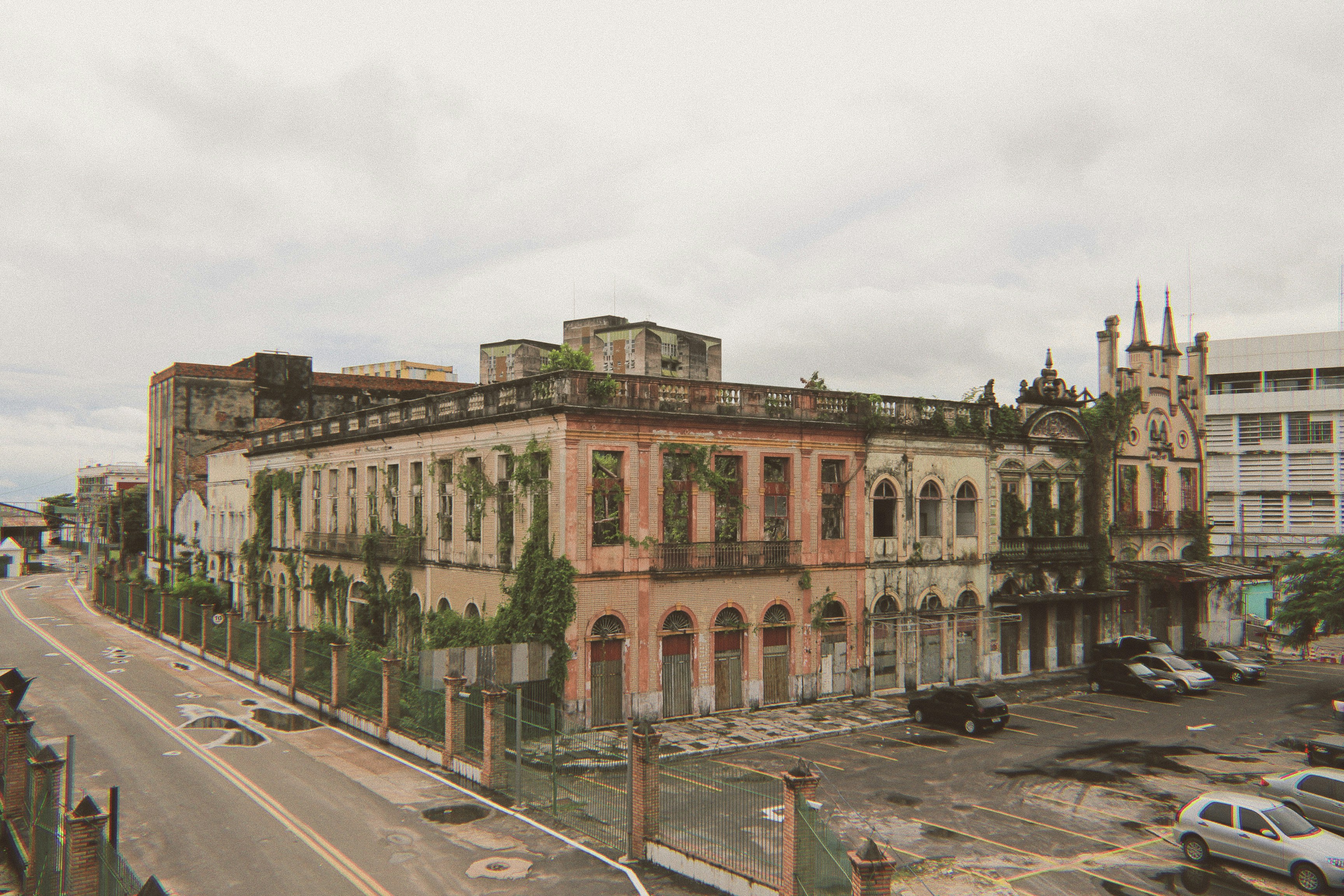 brown concrete building near road during daytime, Urban ruin amid Manaus city