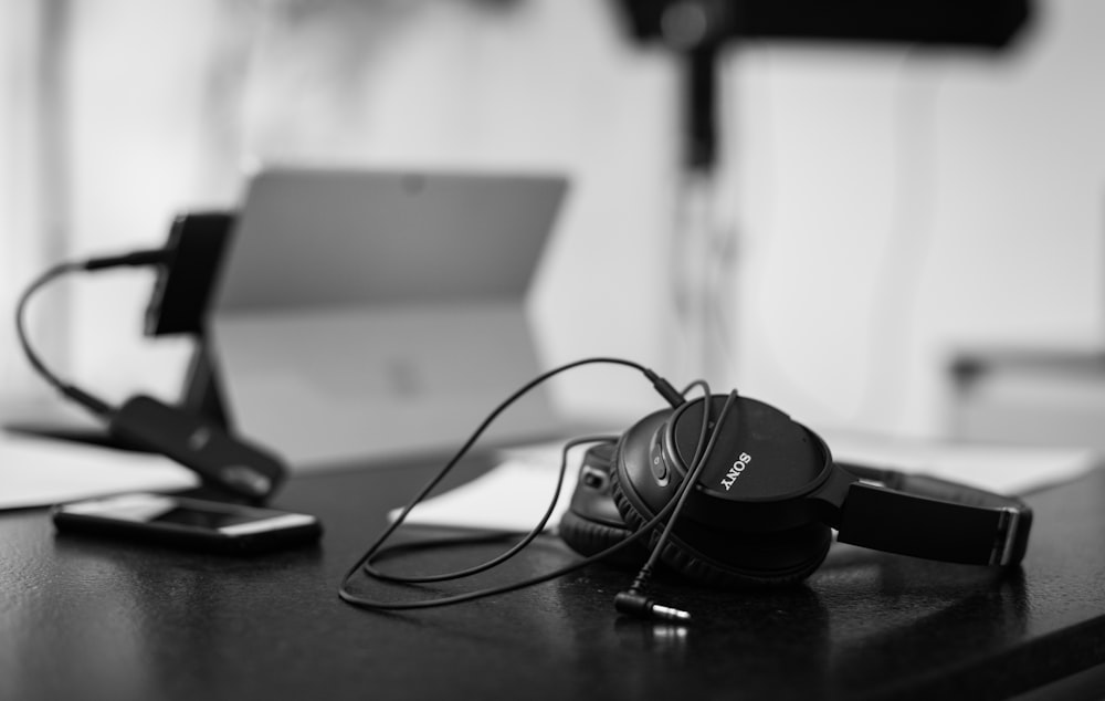 black sony headphones on black table