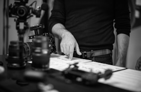 grayscale photo of person pointing to storyboards