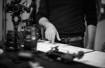 grayscale photo of person pointing to storyboards