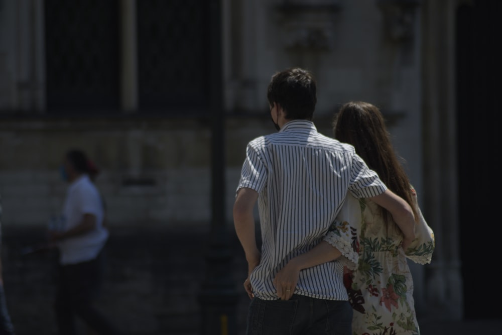 man and woman kissing during daytime