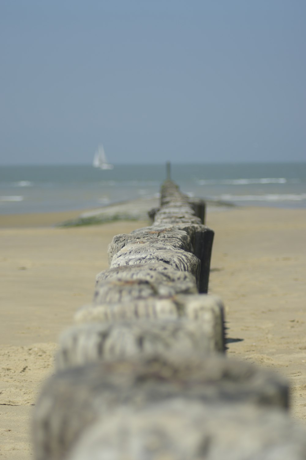 gray concrete fence near body of water during daytime