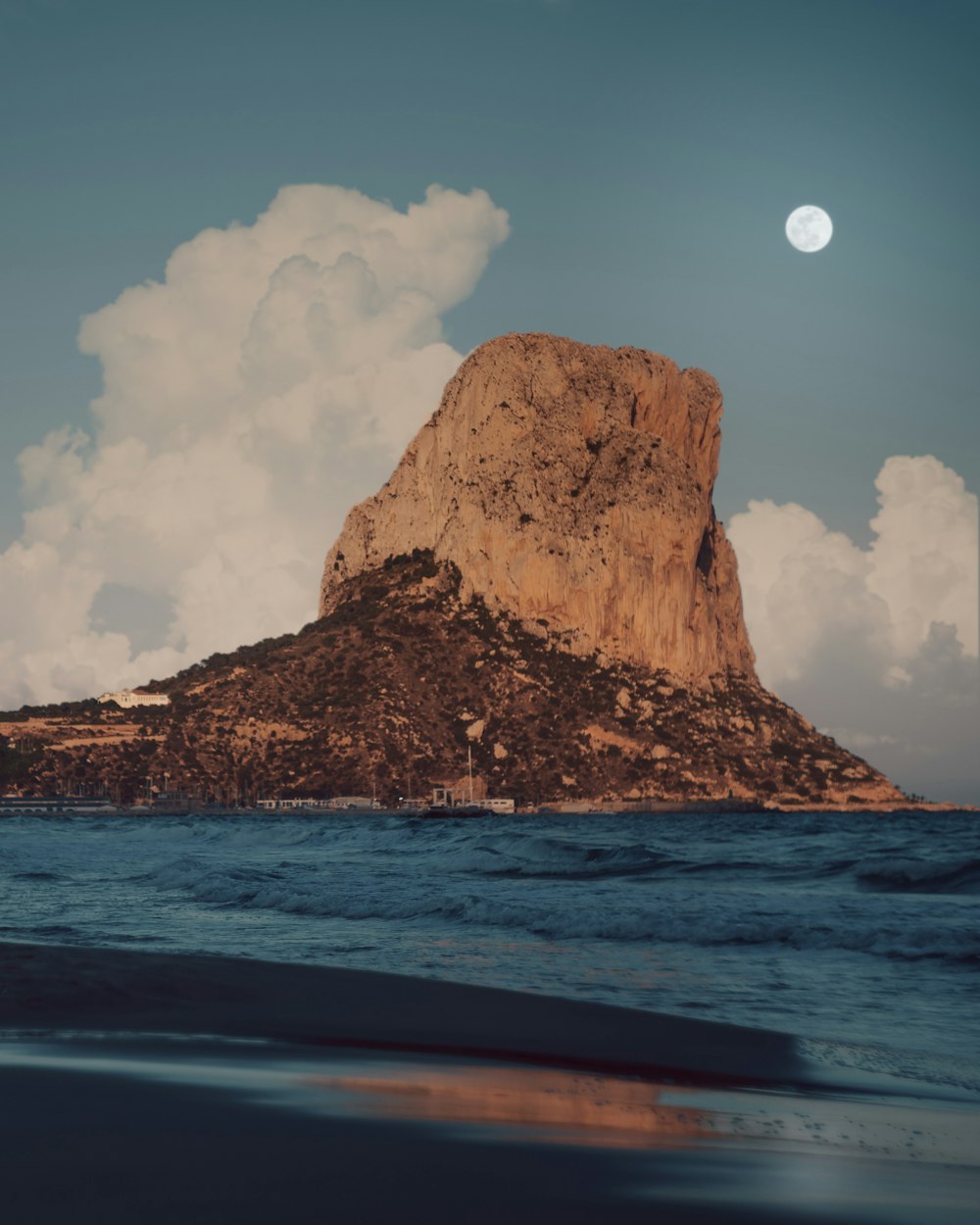 brown rock formation on sea during daytime