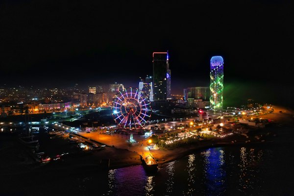 Ferris wheel near body of water during night time — Batumi, Georgia