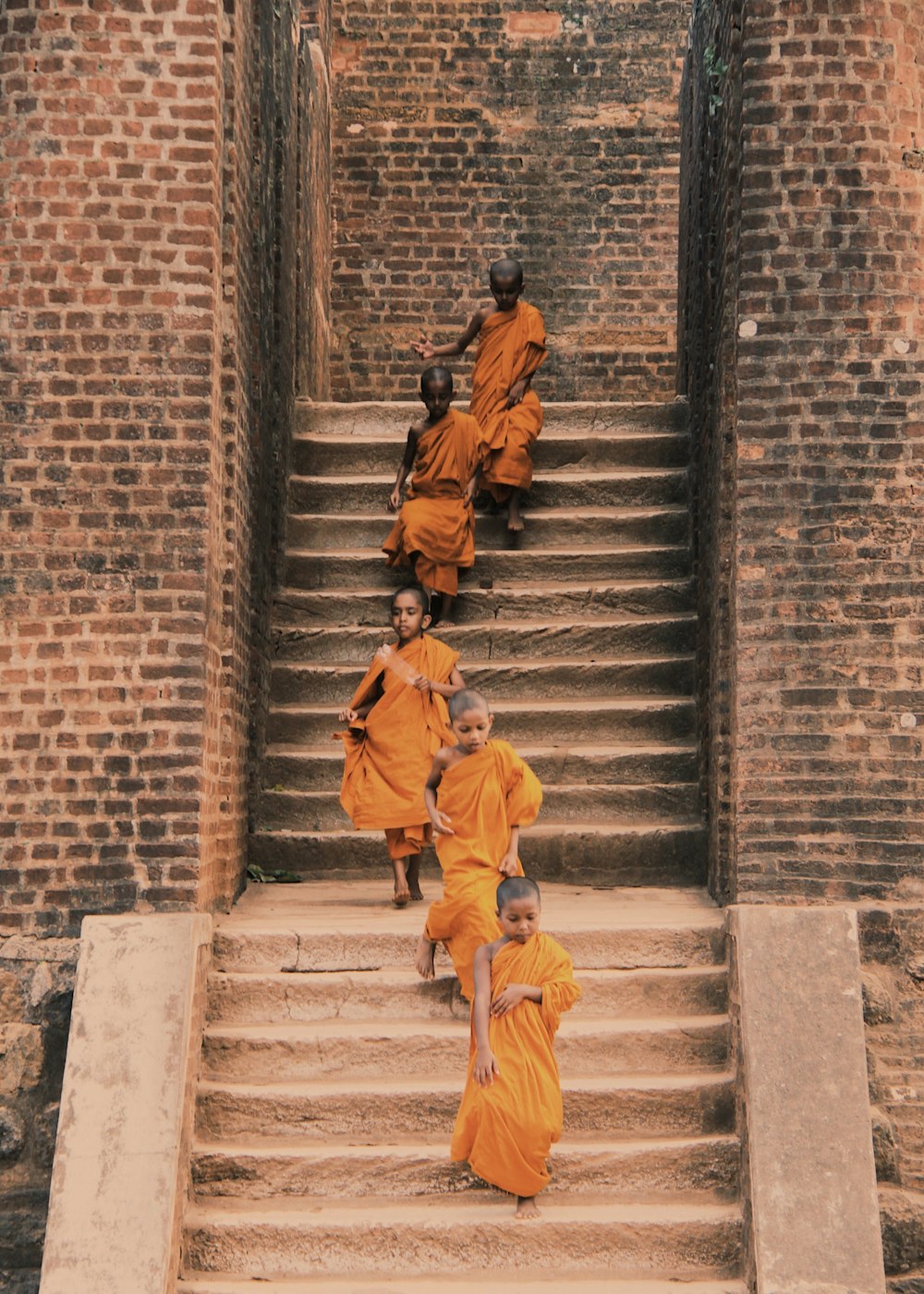 회색 콘크리트 계단을 걷는 노란 재킷을 입은 남자