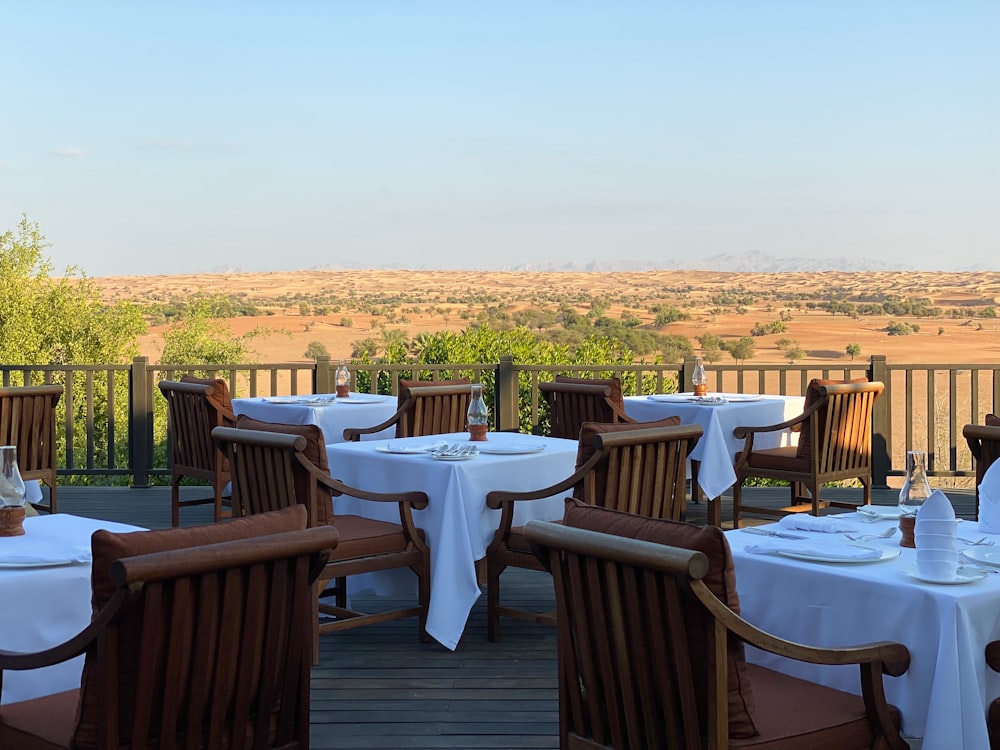 brown wooden table with chairs on brown wooden deck