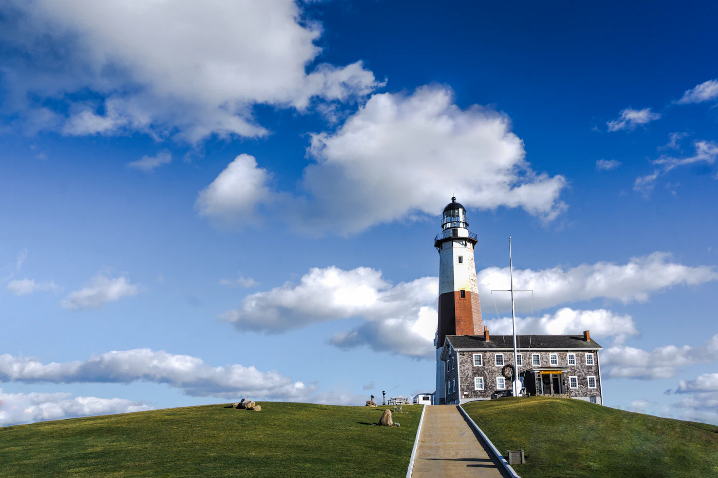 White lighthouse standing against a clear blue sky, a symbol of guidance for the family members a DOHSA claim is meant to protect