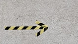 black and yellow arrow sign