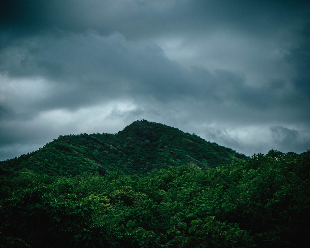 green mountain under gray clouds