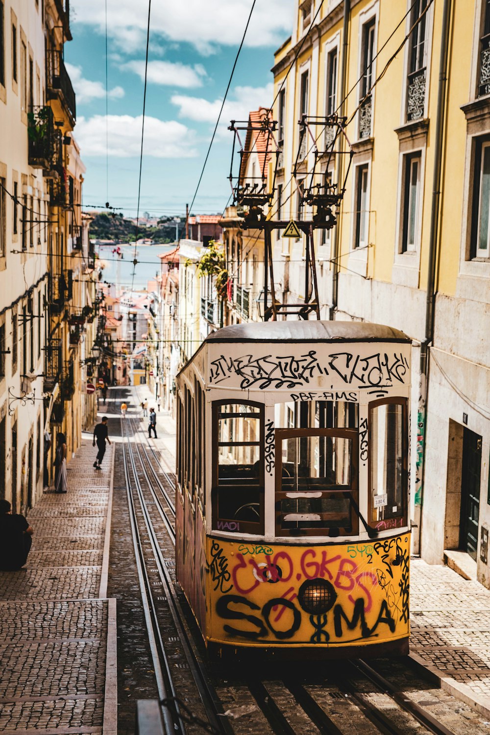 white and yellow tram on street during daytime