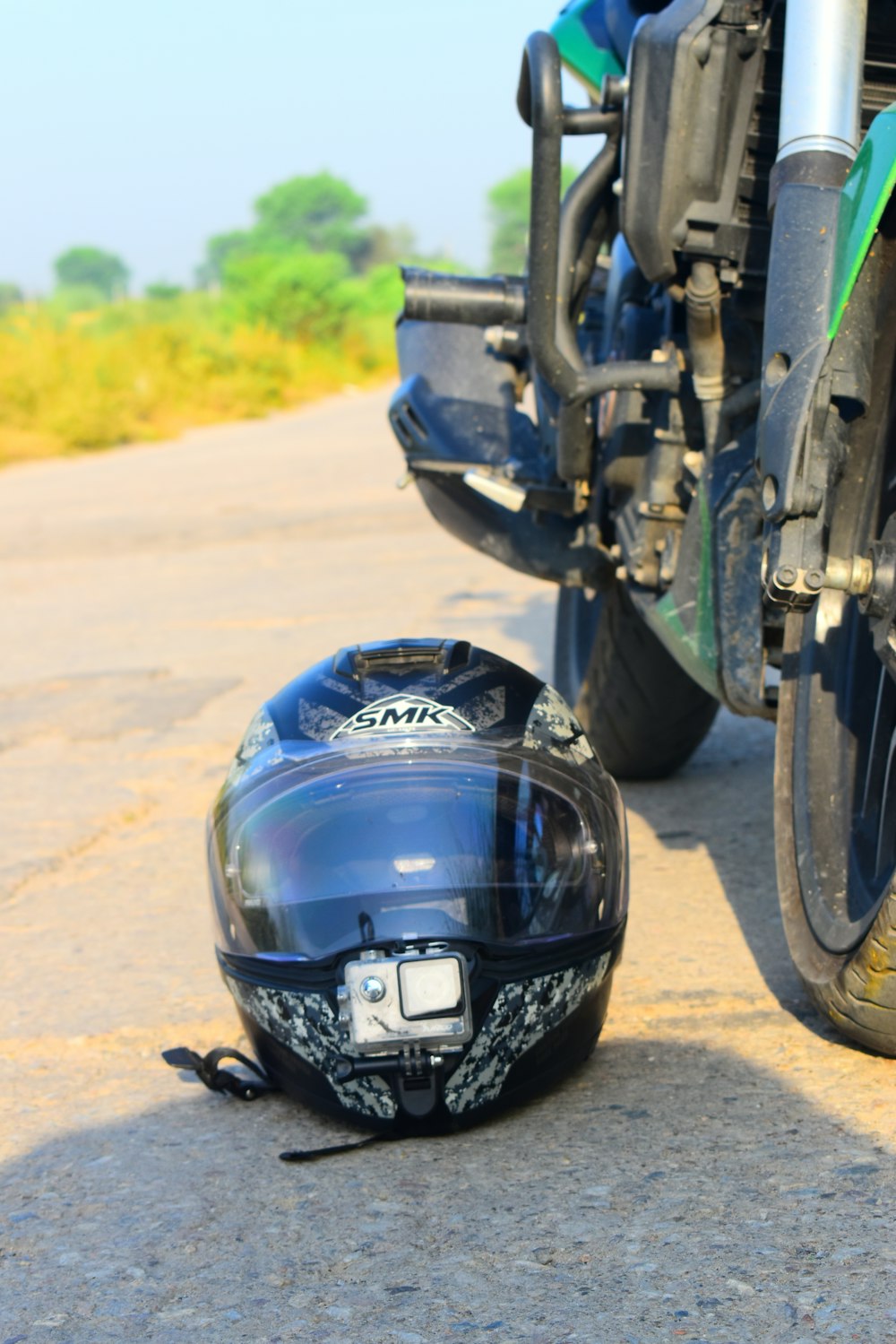 black and blue motorcycle helmet on motorcycle wheel