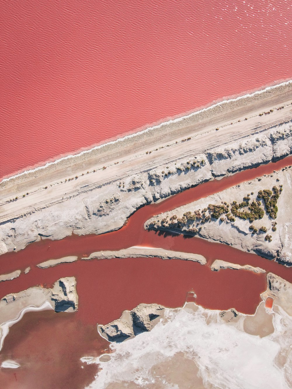 an aerial view of a body of water with red water