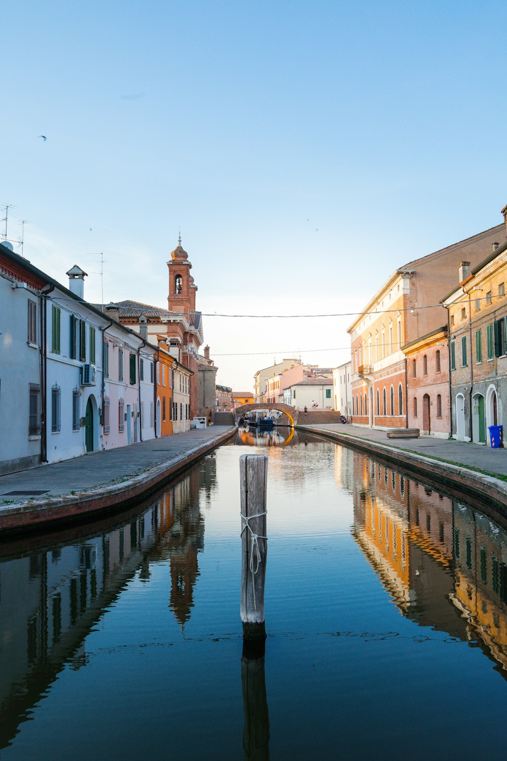 boat on river between buildings during daytime