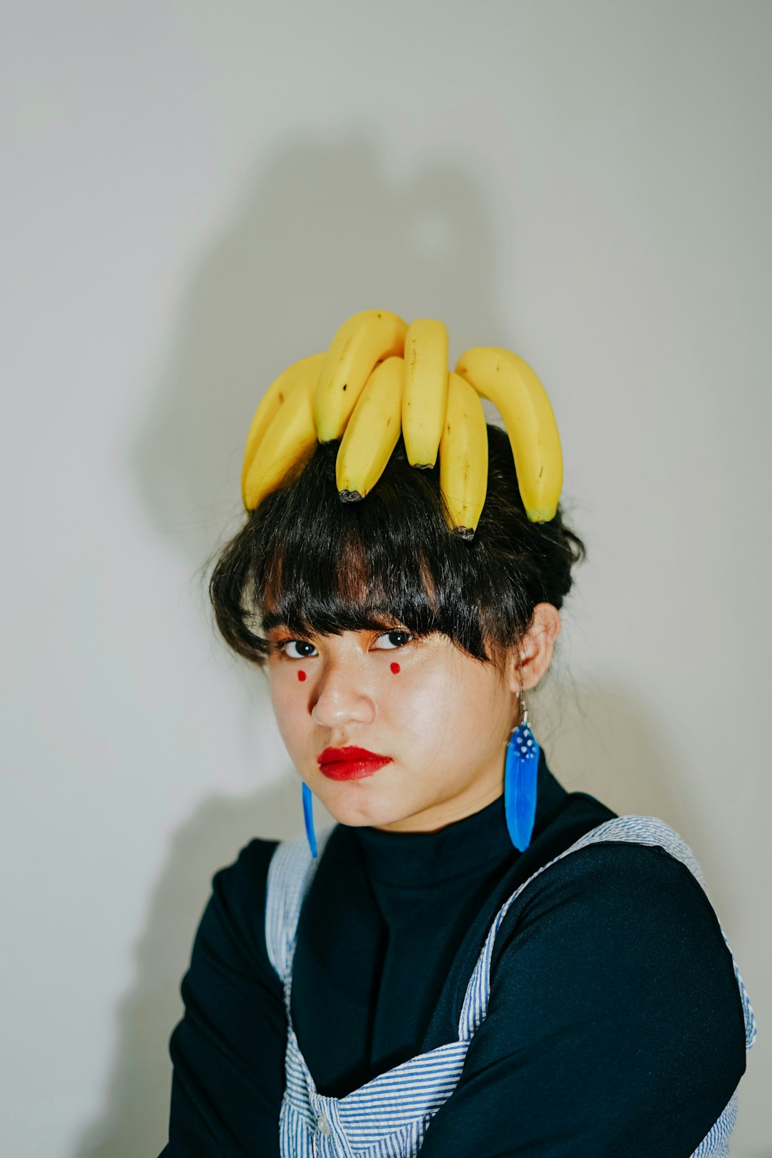 boy in black hoodie holding yellow banana