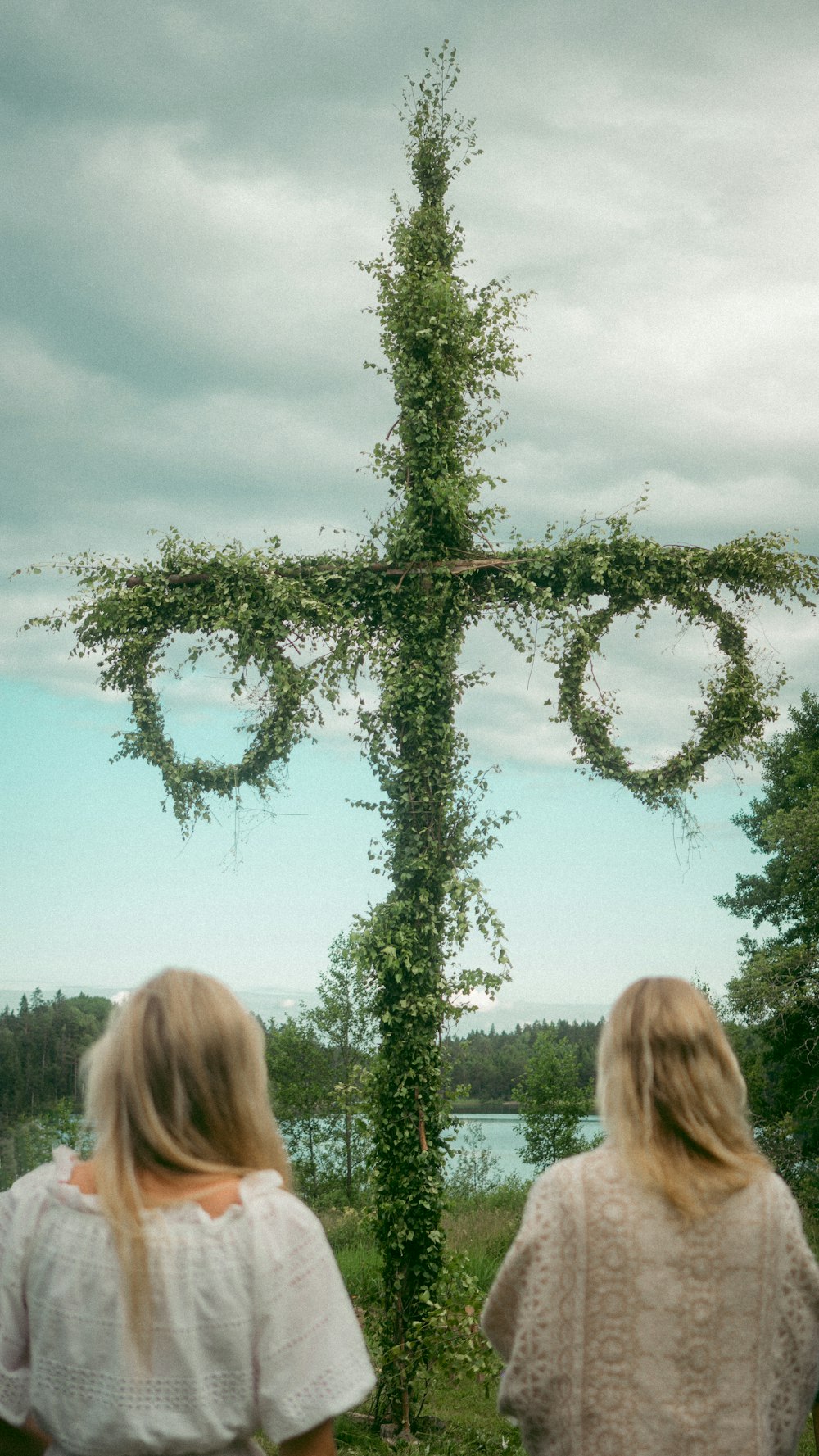 woman standing near green tree during daytime