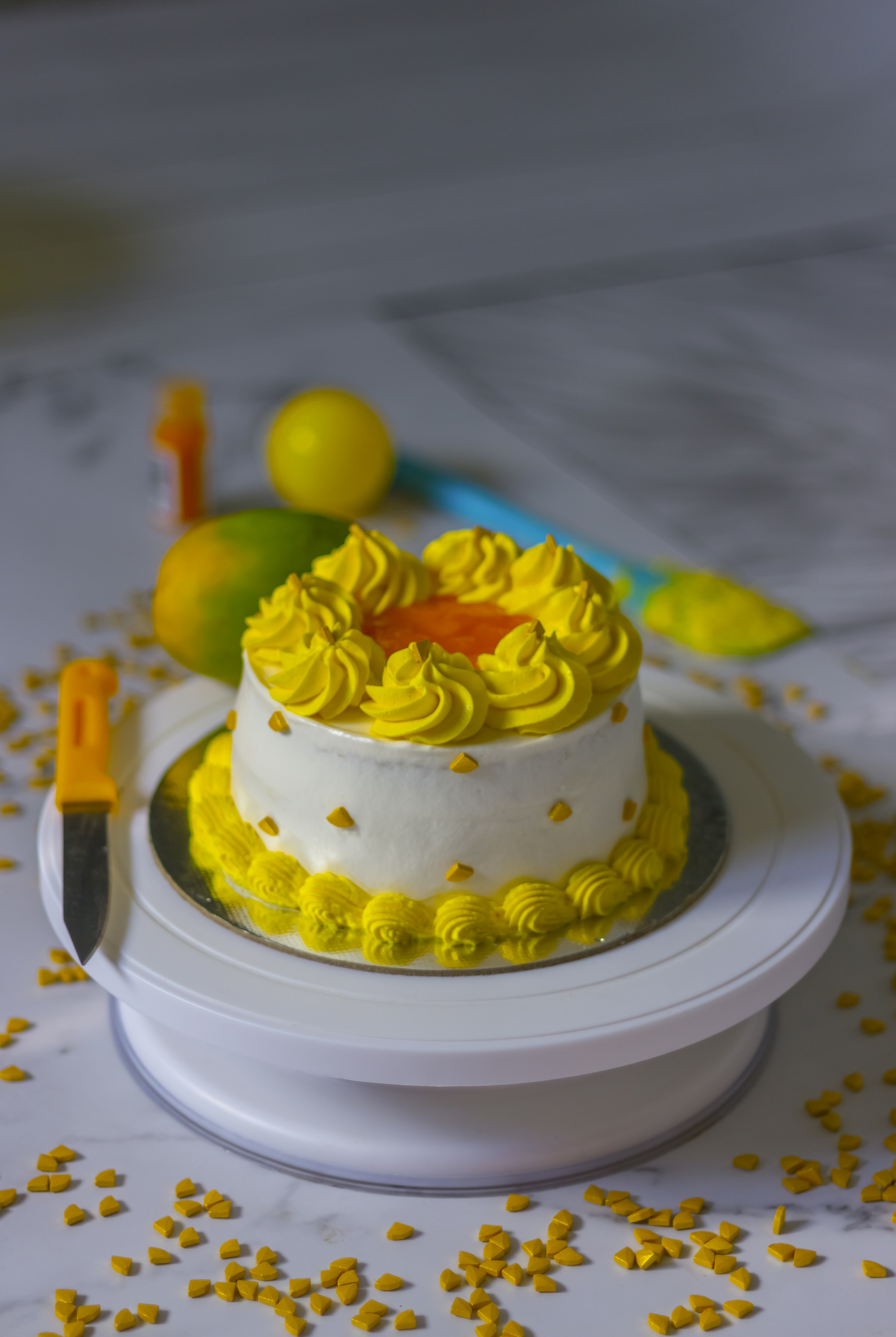 white and blue cake with yellow and green icing on top