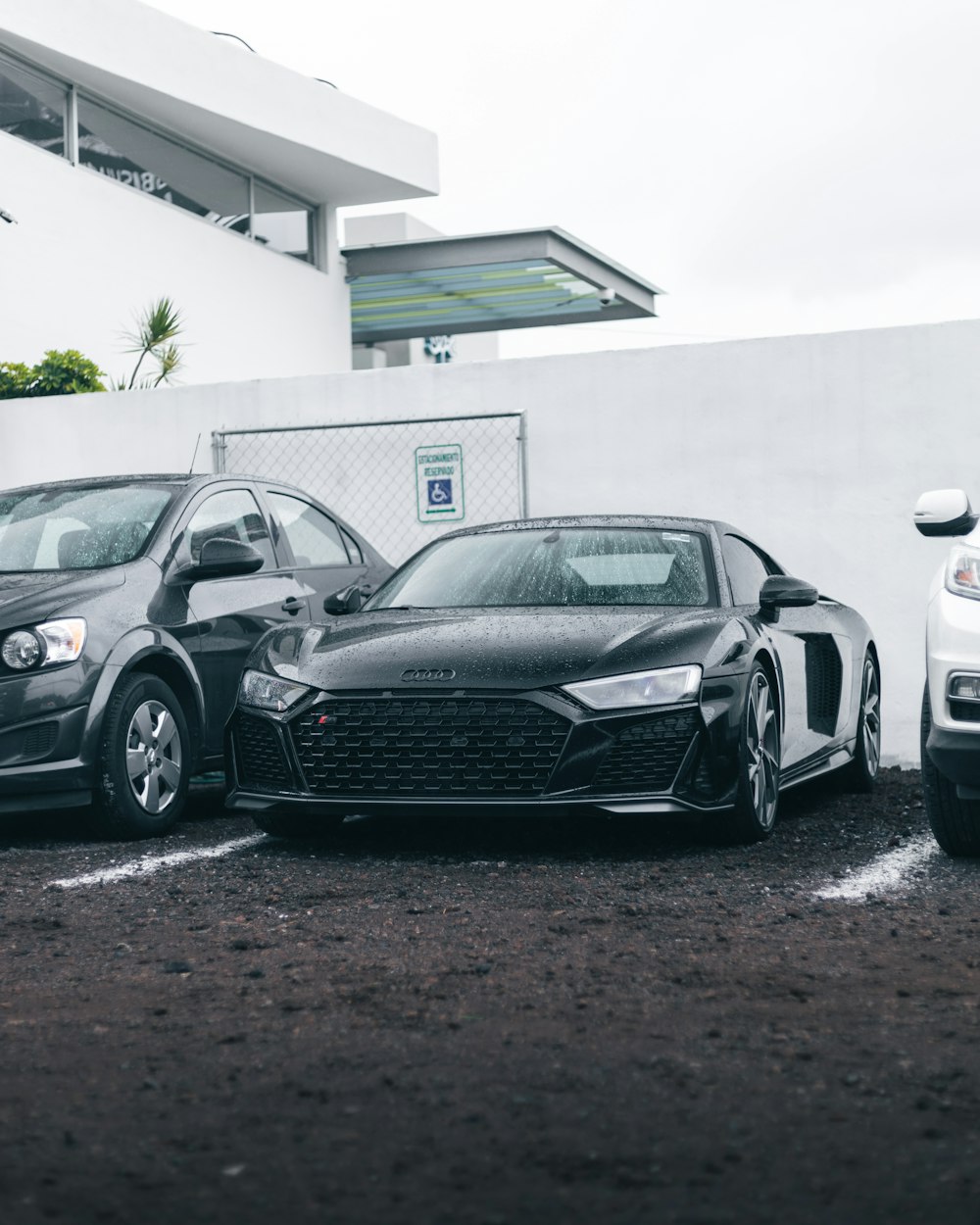 black bmw coupe parked beside white car