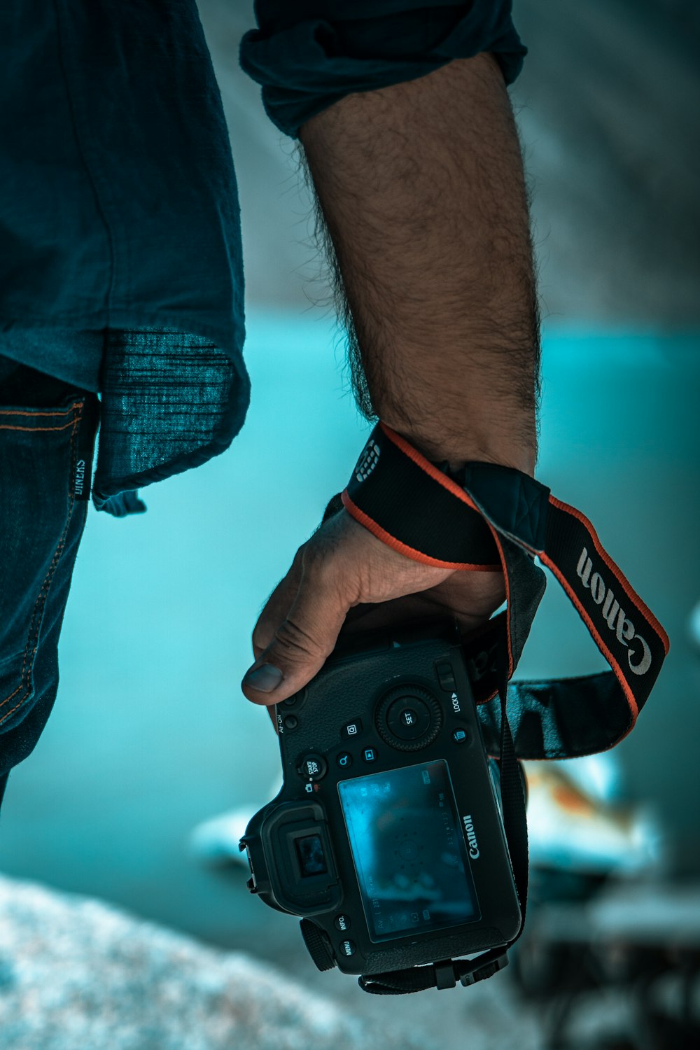 person holding black canon dslr camera