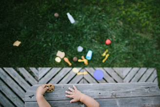 person sitting on brown wooden floor