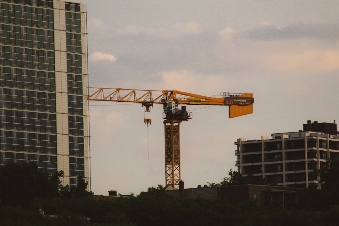 yellow crane near building during daytime