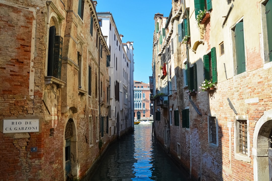 river between concrete buildings during daytime