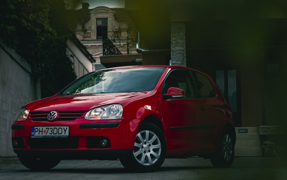 a red car parked in front of a building