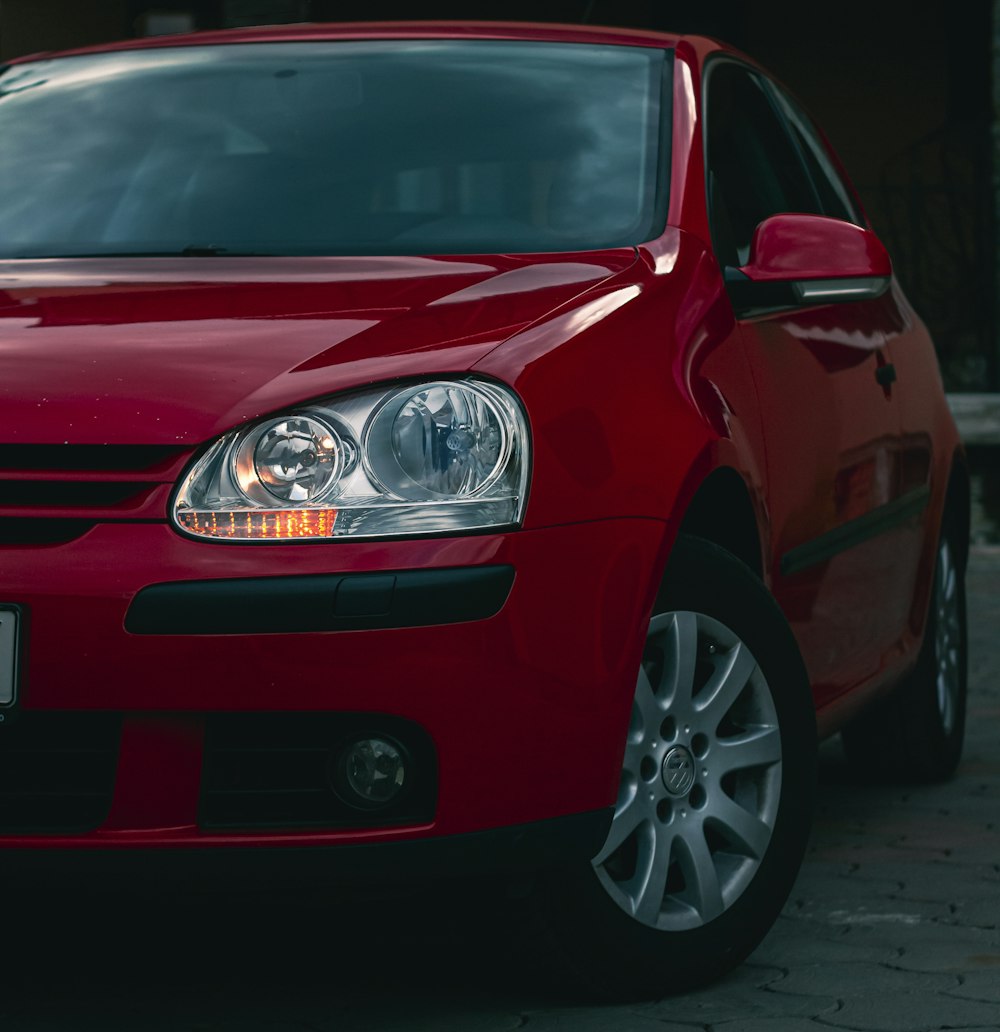 a red car parked in front of a building