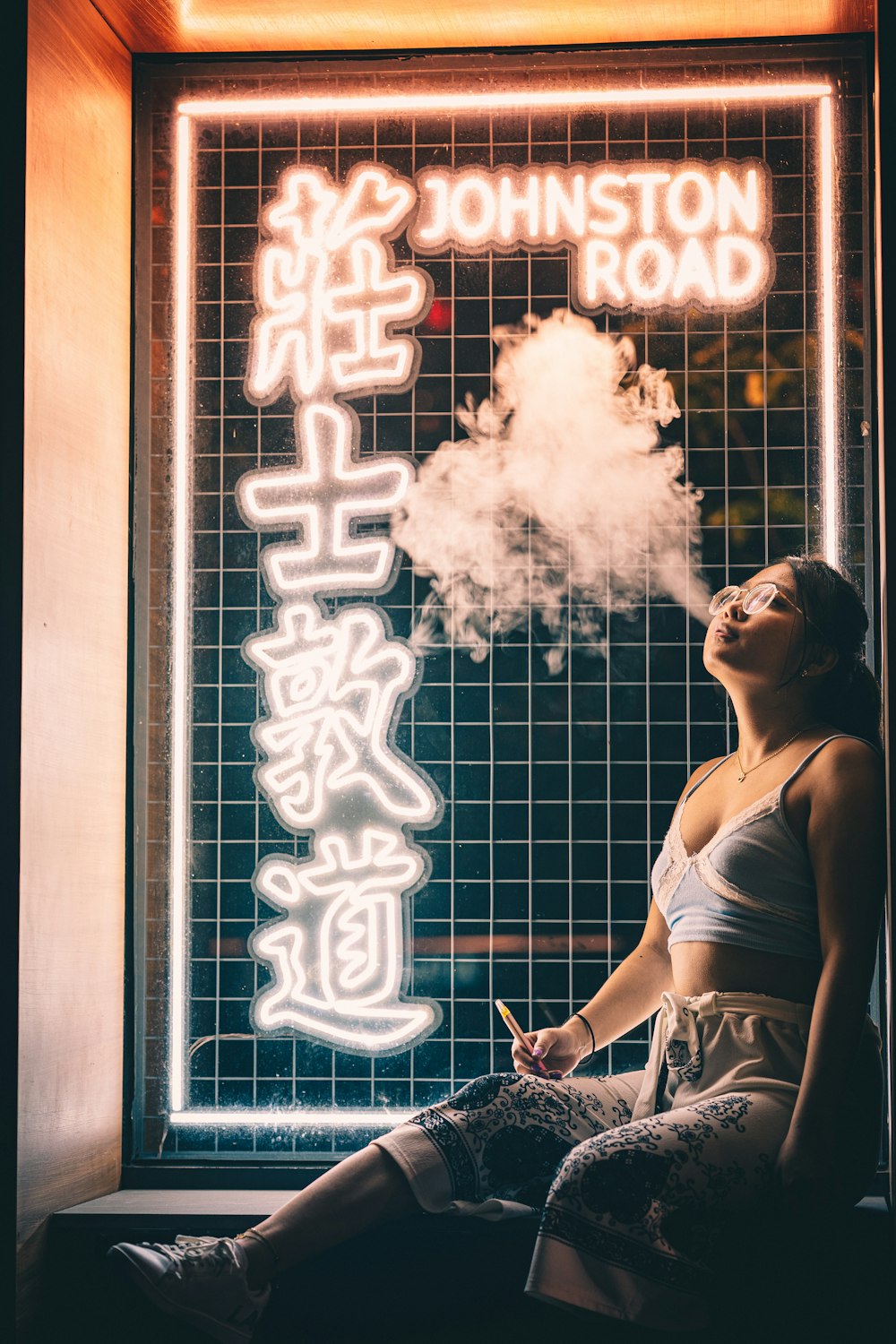 woman in white tank top smoking