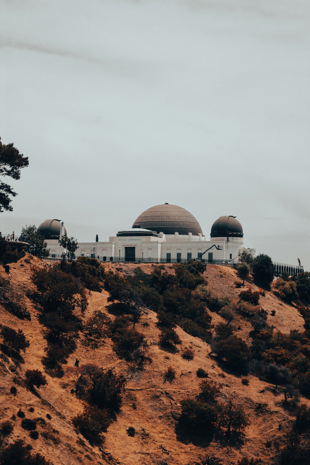 white dome building on brown rock mountain during daytime