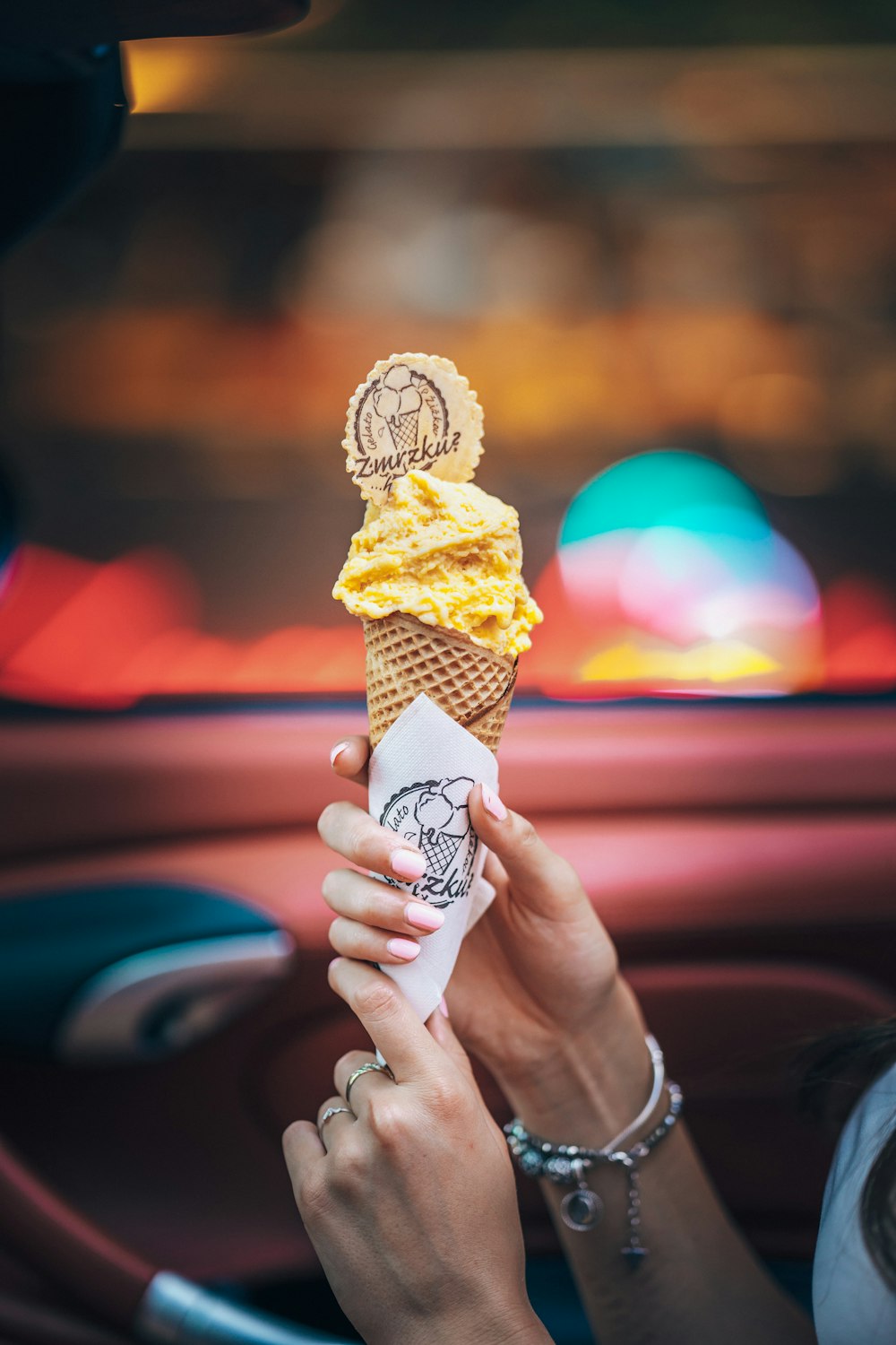 person holding ice cream cone with cone