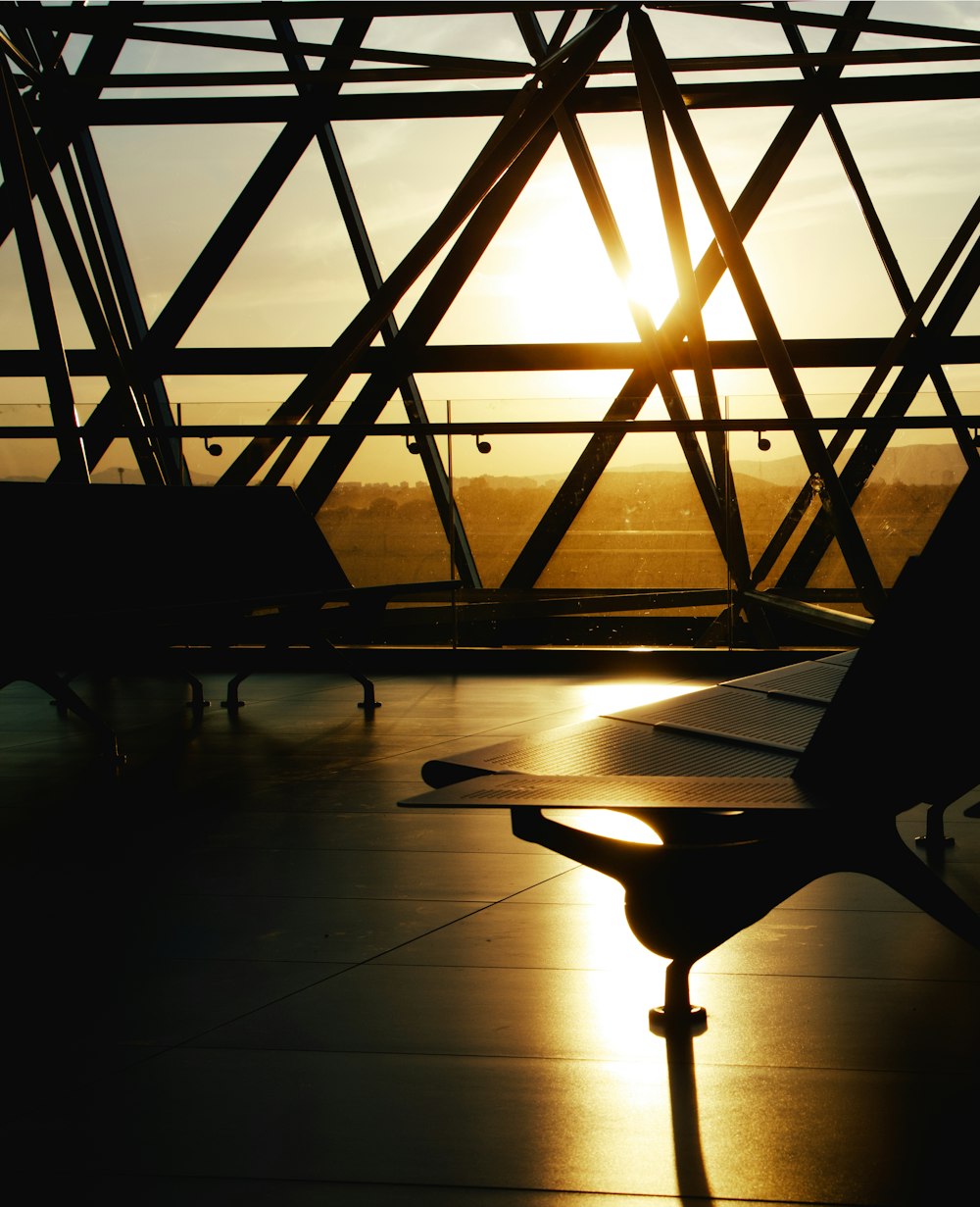 silhouette of person sitting on bench during sunset