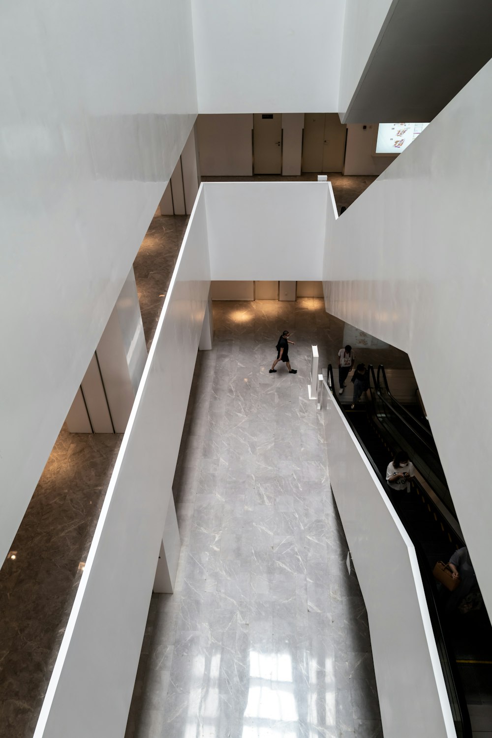 people walking on hallway inside building