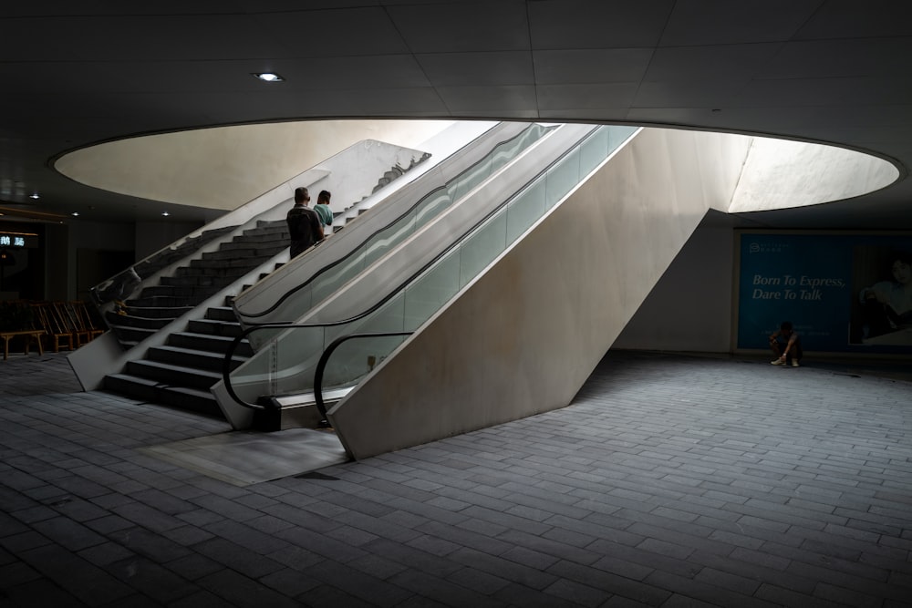 man in black jacket walking on gray concrete stairs