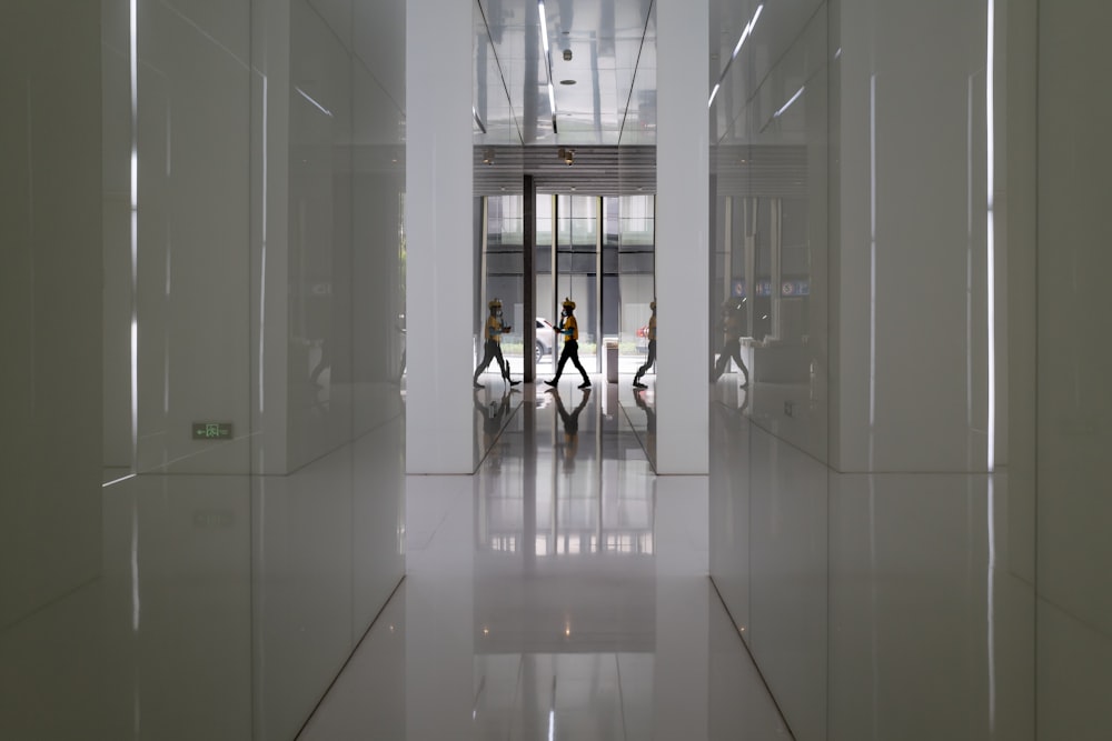 people walking on hallway inside building