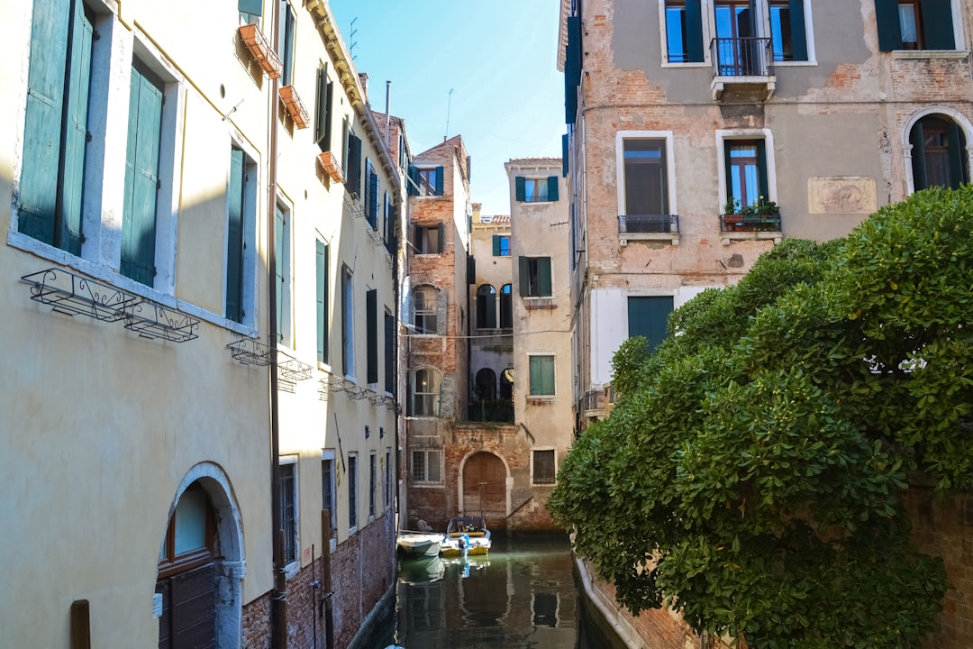 river between concrete buildings during daytime