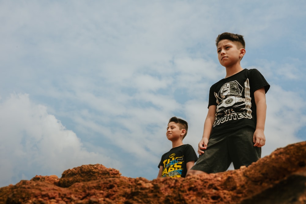 2 hombres de pie en Brown Rock durante el día