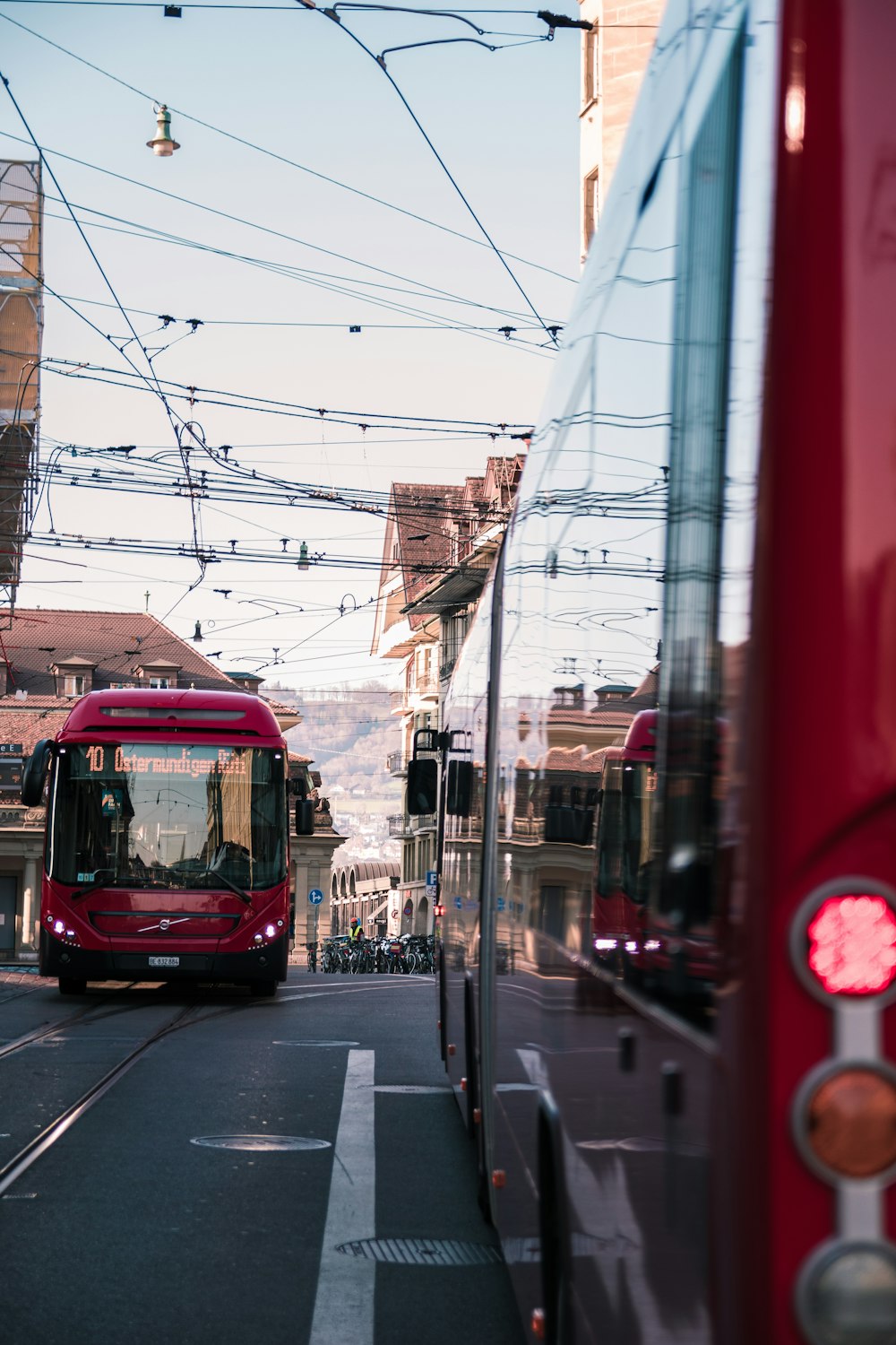 red and black bus on road during daytime