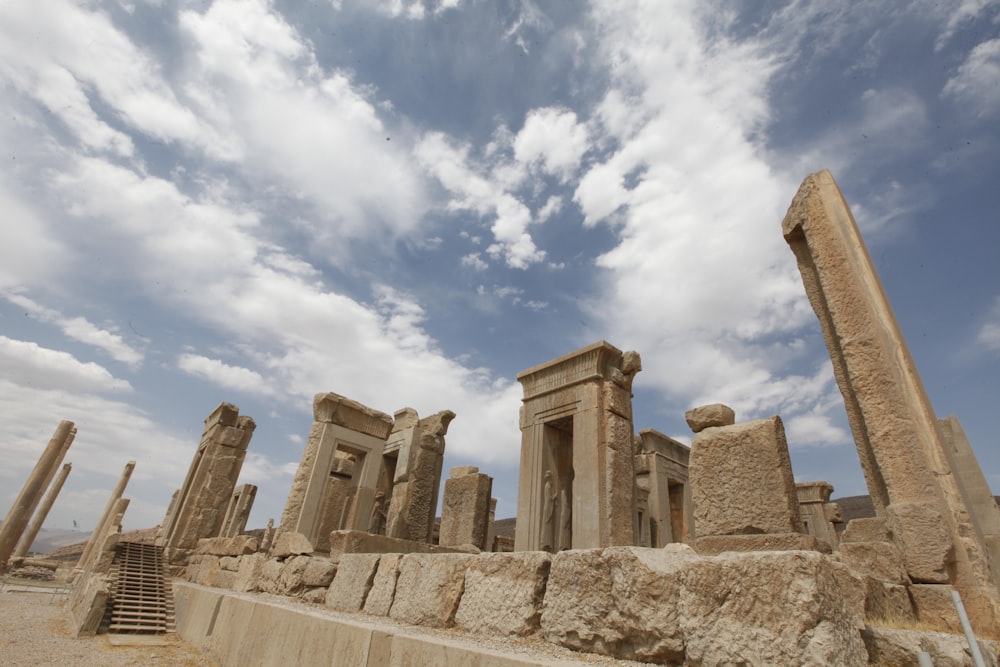 brown concrete ruins under blue sky and white clouds during daytime