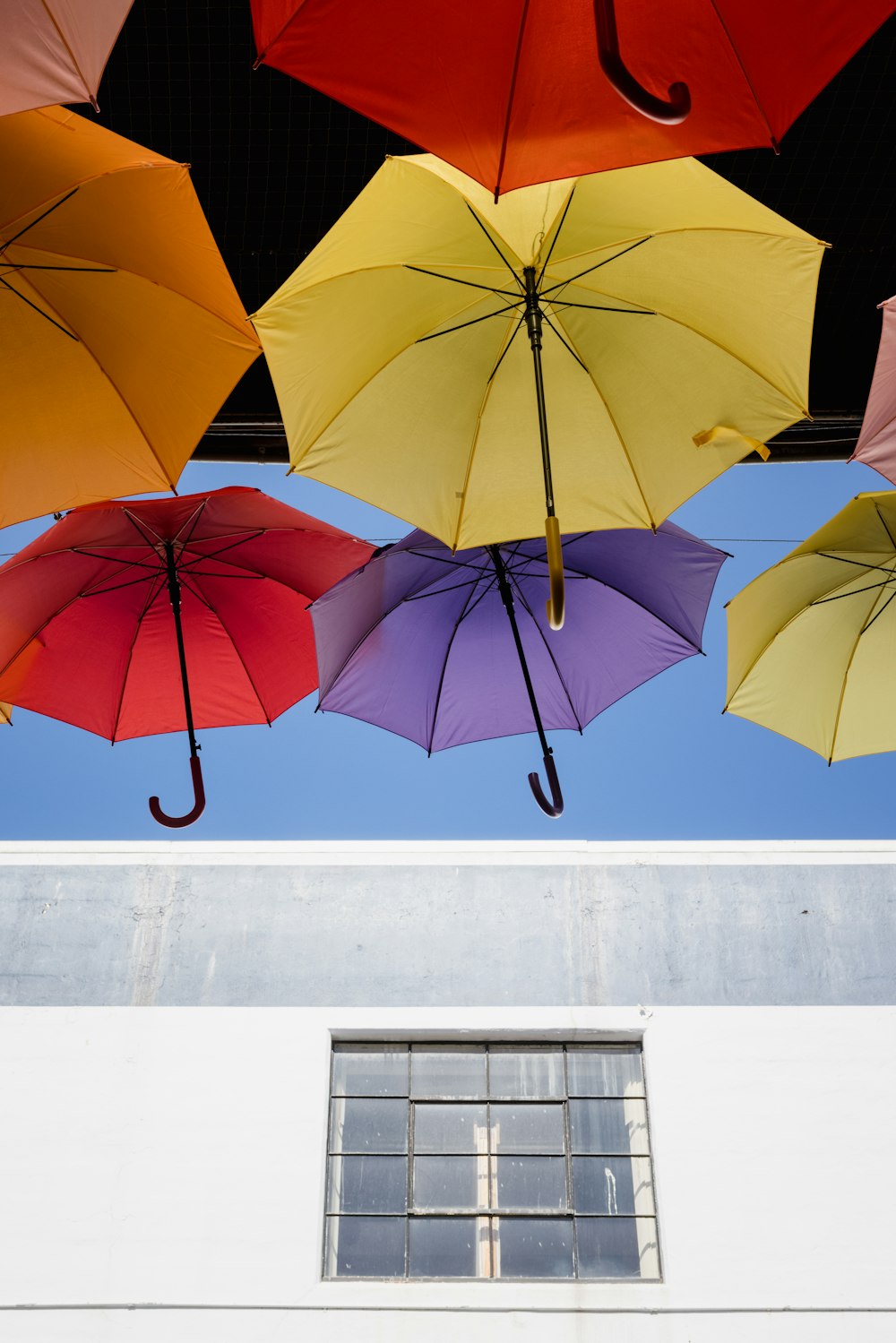 orange umbrella on white wall