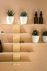 black glass bottles on white wooden shelf