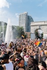 people gathering near fountain during daytime